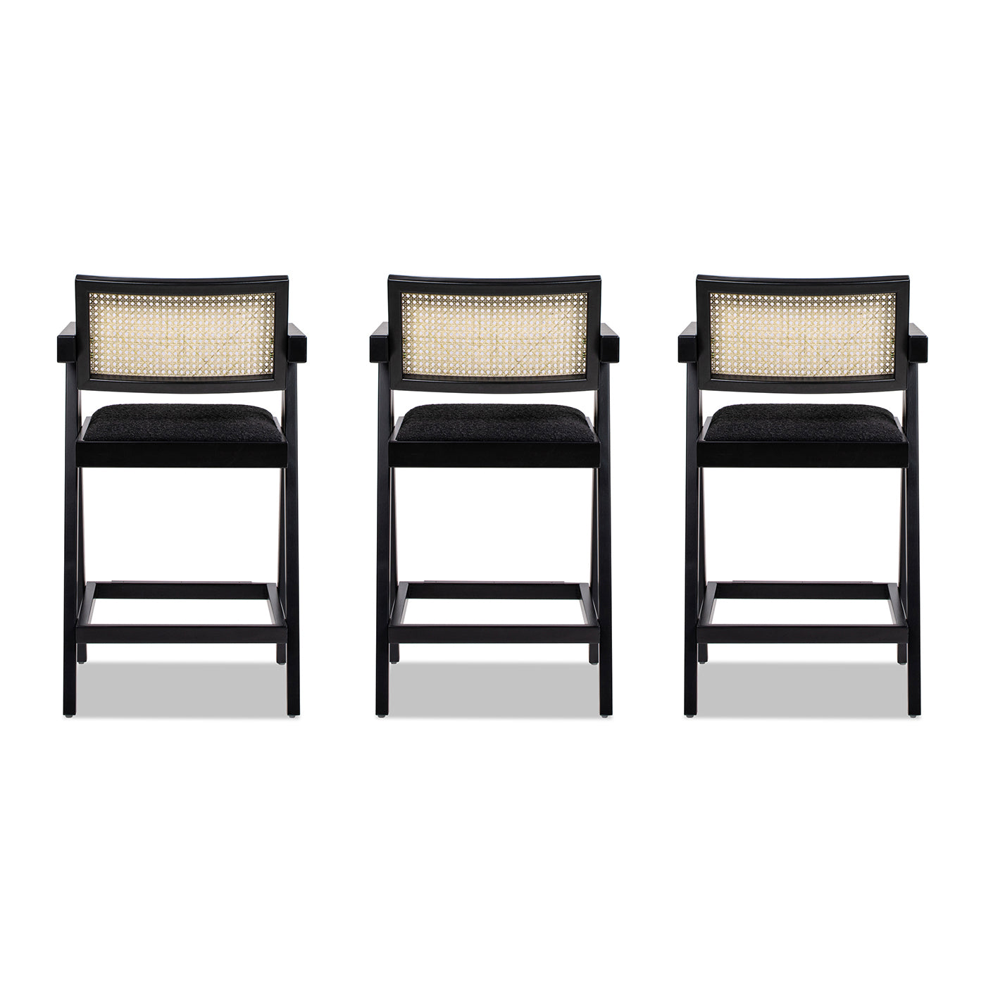 Three black cane back bar stools with dark upholstered seats