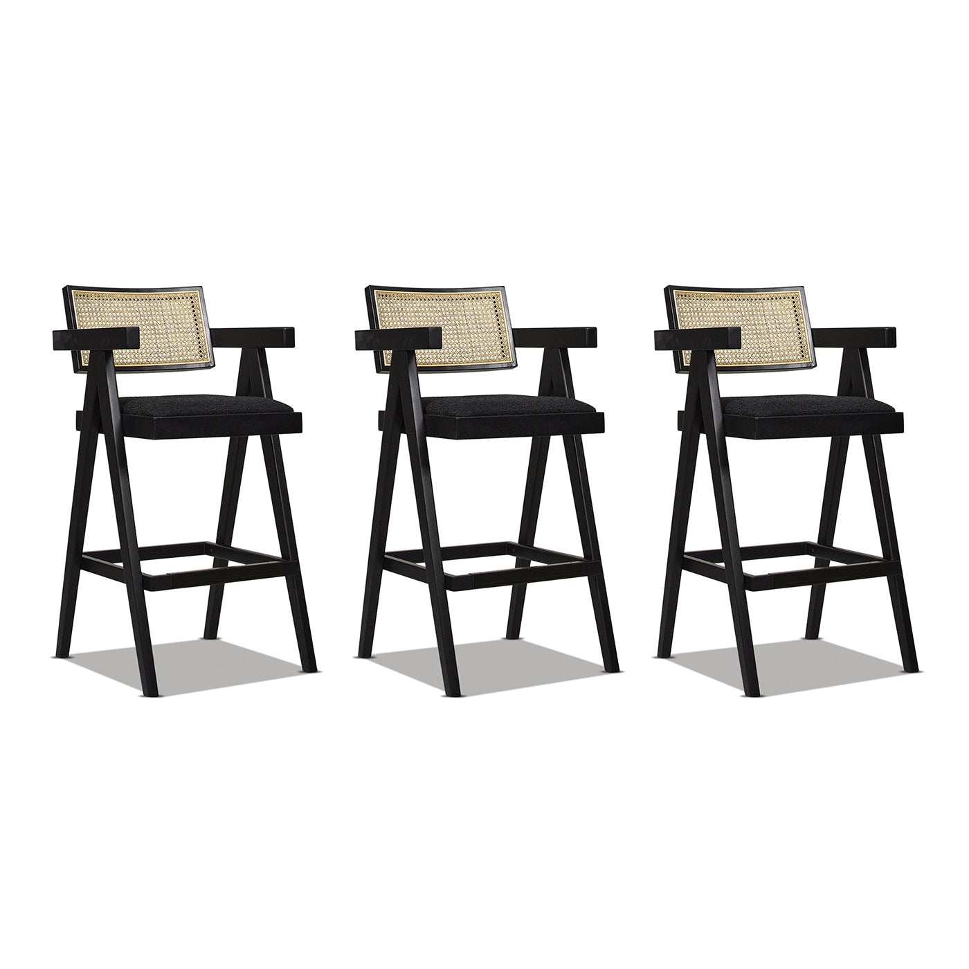Three black wooden bar stools with rattan backs and dark seat cushions