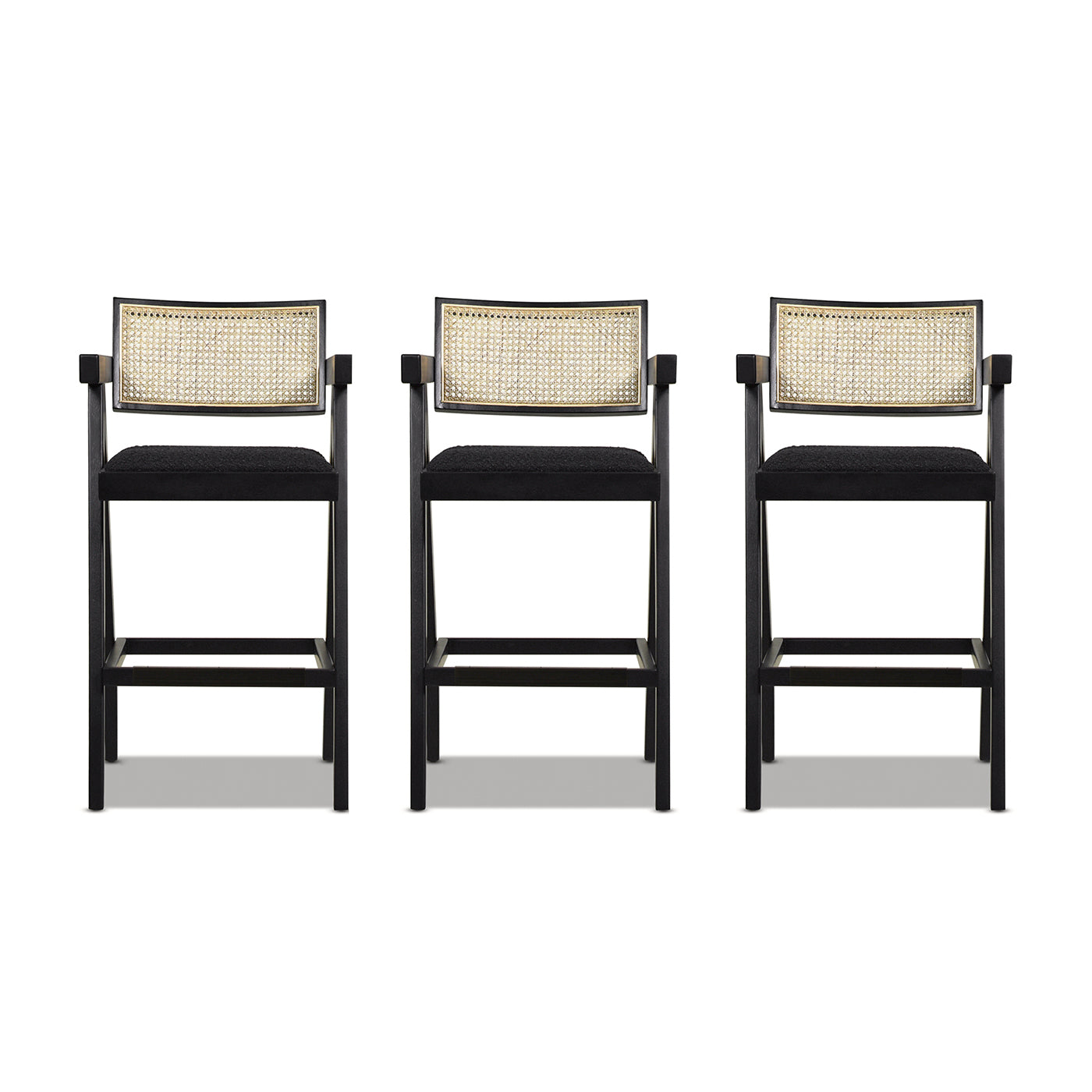 Three black bar stools with cane backs and upholstered seats