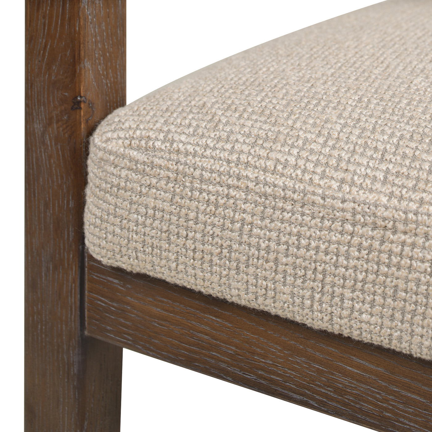 Closeup of a beige woven upholstered seat on a rustic wood frame chair