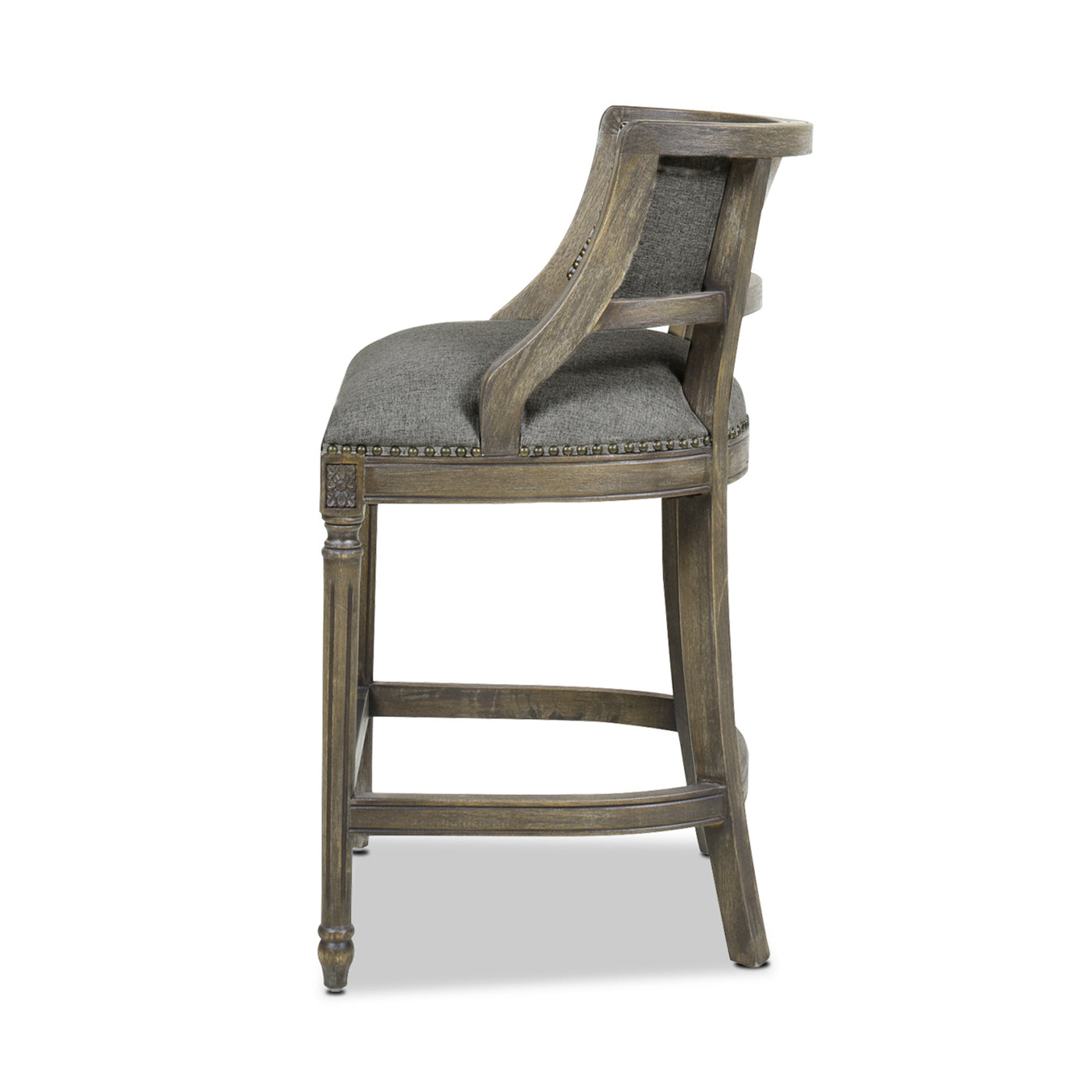 Upholstered grey fabric bar stool with carved wooden legs and studded trim