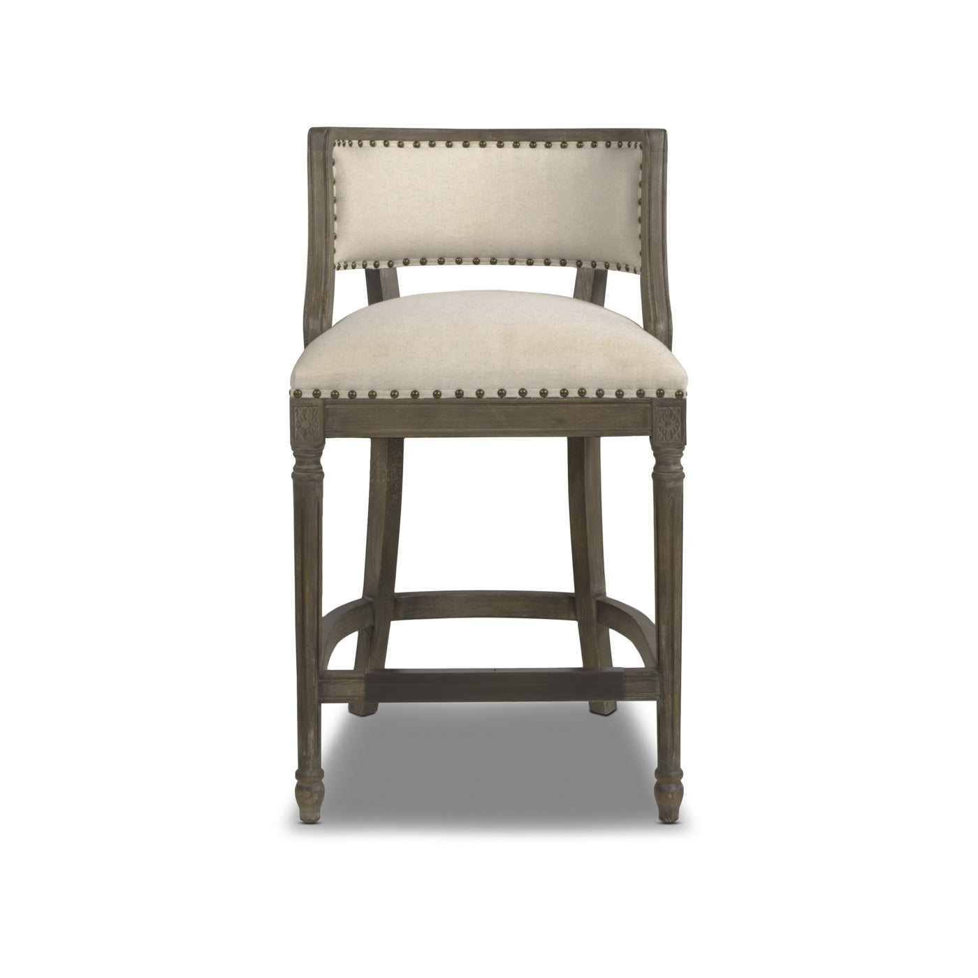 Upholstered beige bar stool with nailhead trim and a distressed wood frame