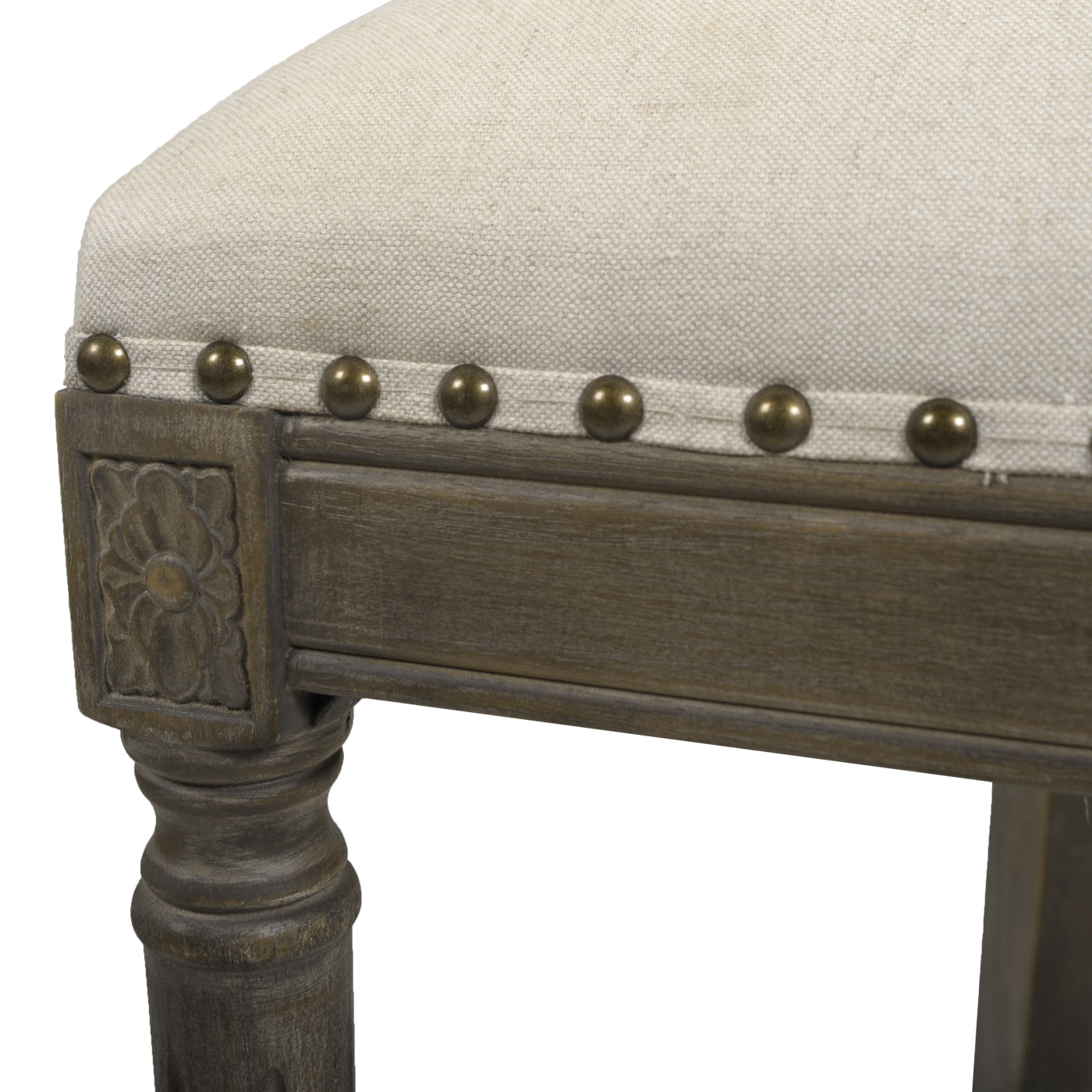 Upholstered bar stool with antique brass nailhead trim and carved wood detail