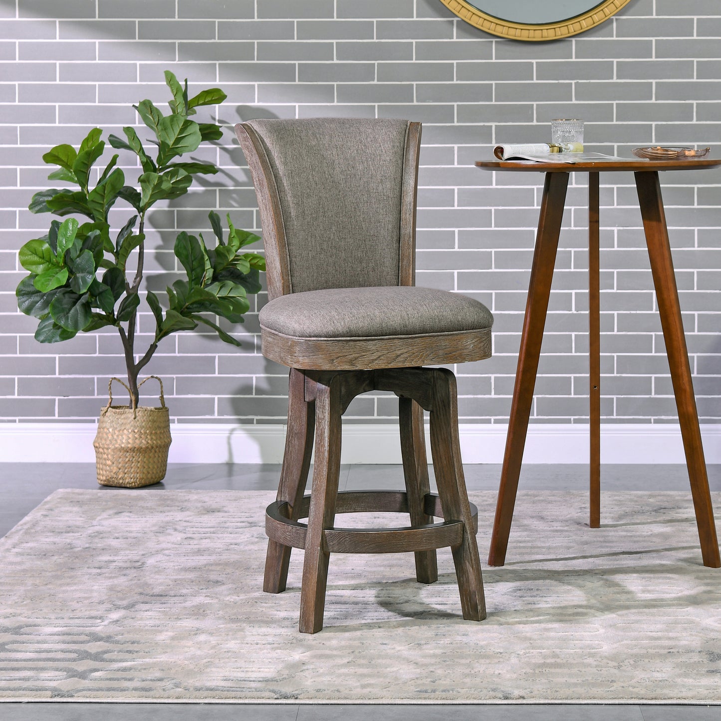 Gray upholstered swivel bar stool with distressed wood base on a modern rug