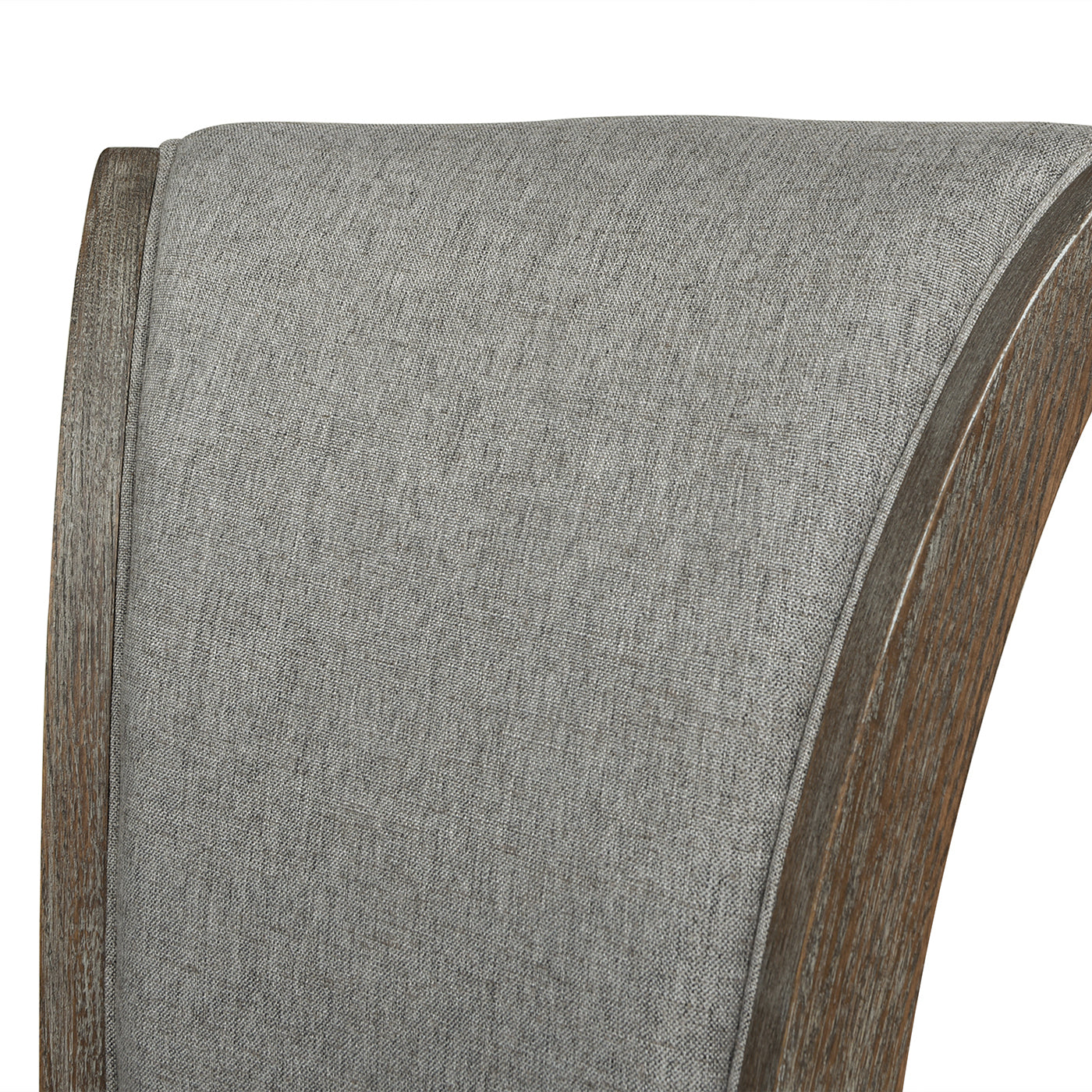 Closeup of a grey linen upholstered chair back with a curved dark wood frame