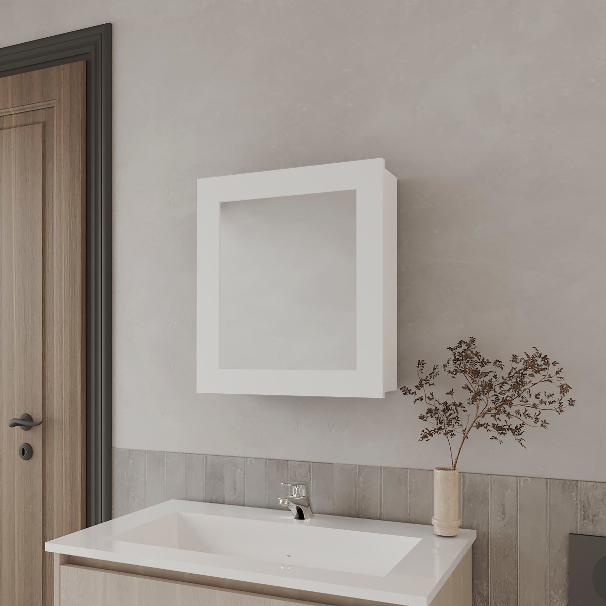 White framed medicine cabinet with mirror above a vanity sink
