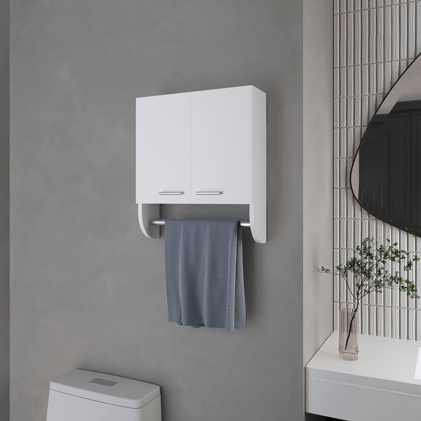 White bathroom cabinet with towel bar holding a gray towel