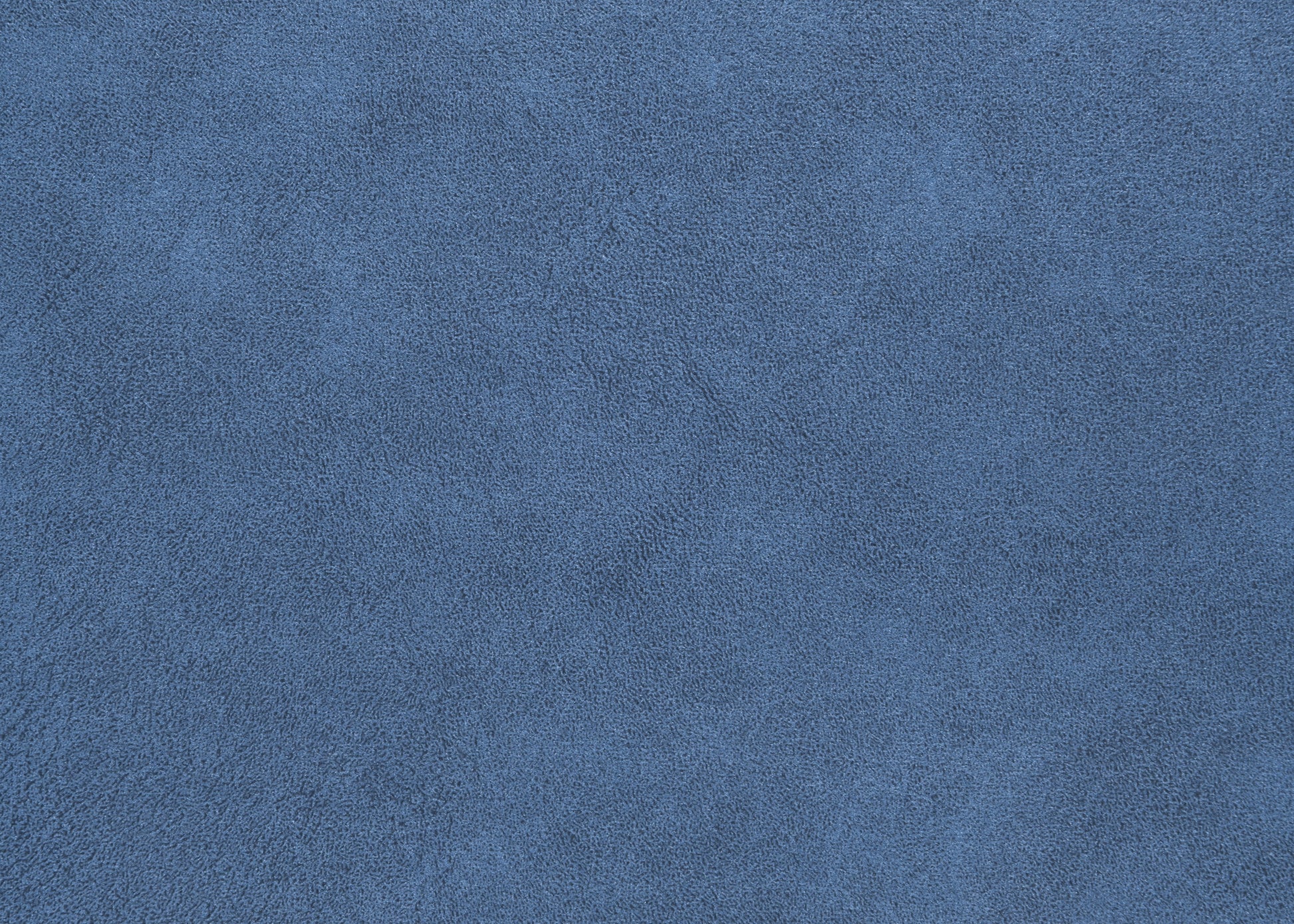 Textured navy blue suede fabric closeup for upholstery and crafts