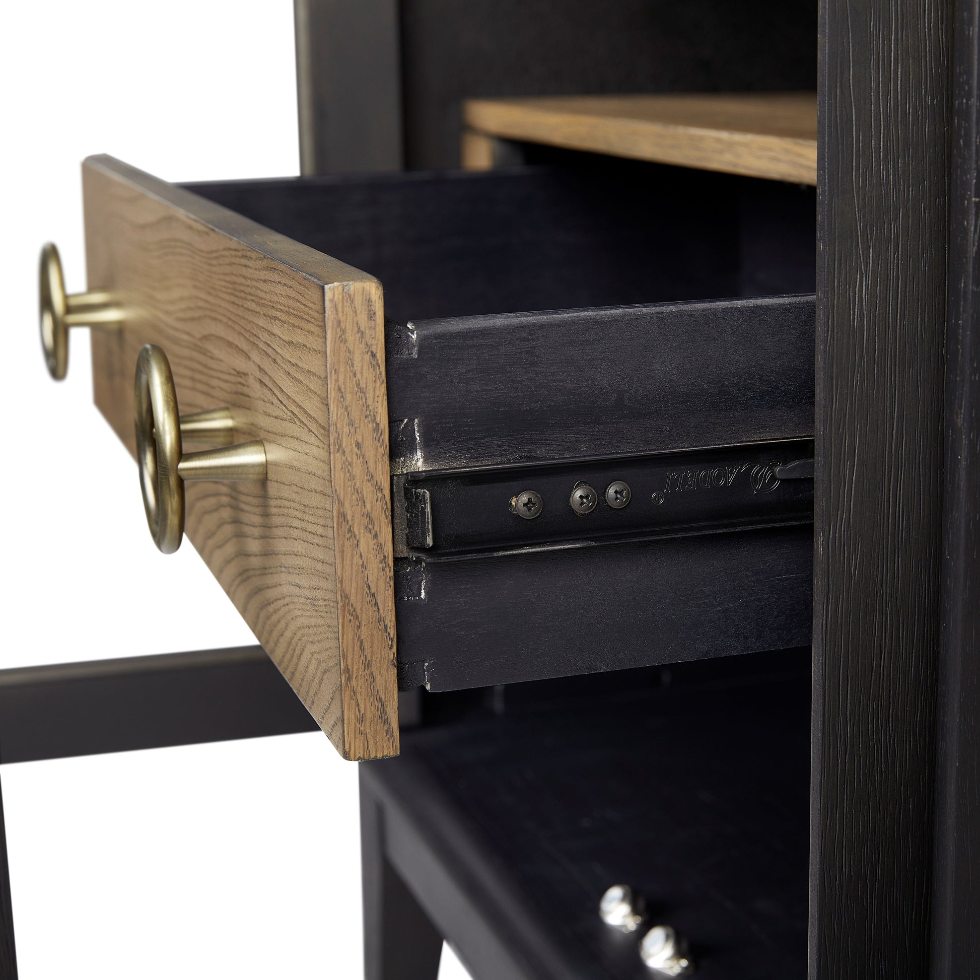 Black dresser drawer with golden hardware and oak wood front