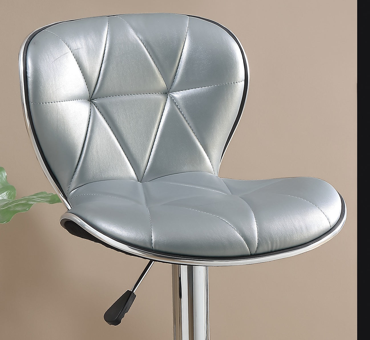Silver quilted faux leather bar stool with chrome accents and adjustable height lever