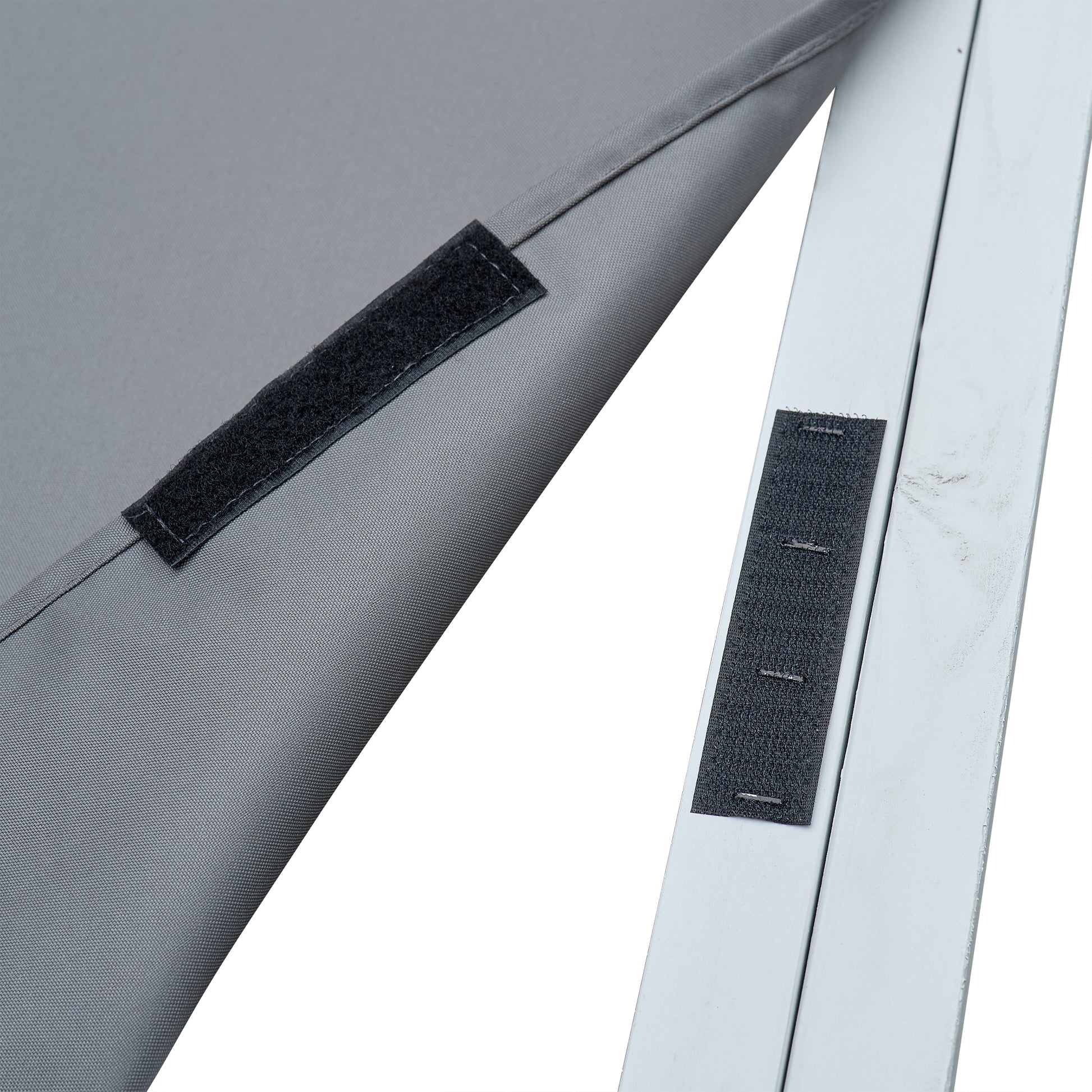 Closeup of grey fabric with black hookandloop fastener attached for securing on a white frame