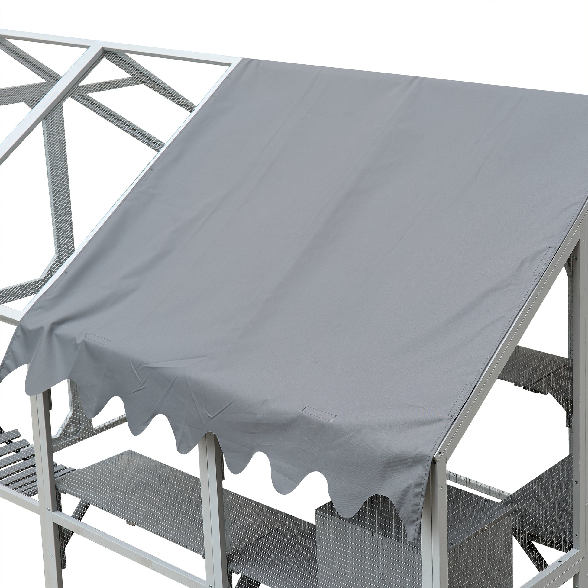 Closeup of a grey fabric canopy with scalloped edges on a wooden and metal chicken coop frame