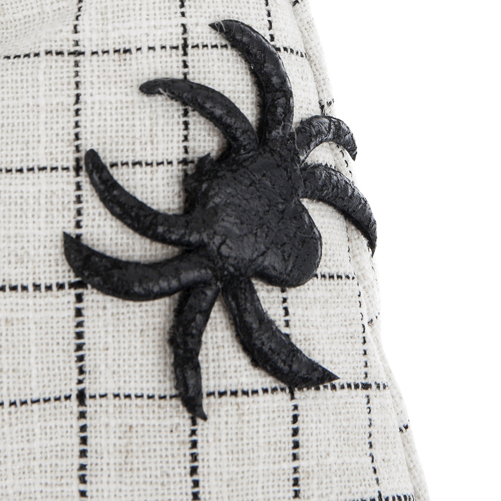 Black spider applique on a textured white fabric with a grid pattern a spooky Halloween accent