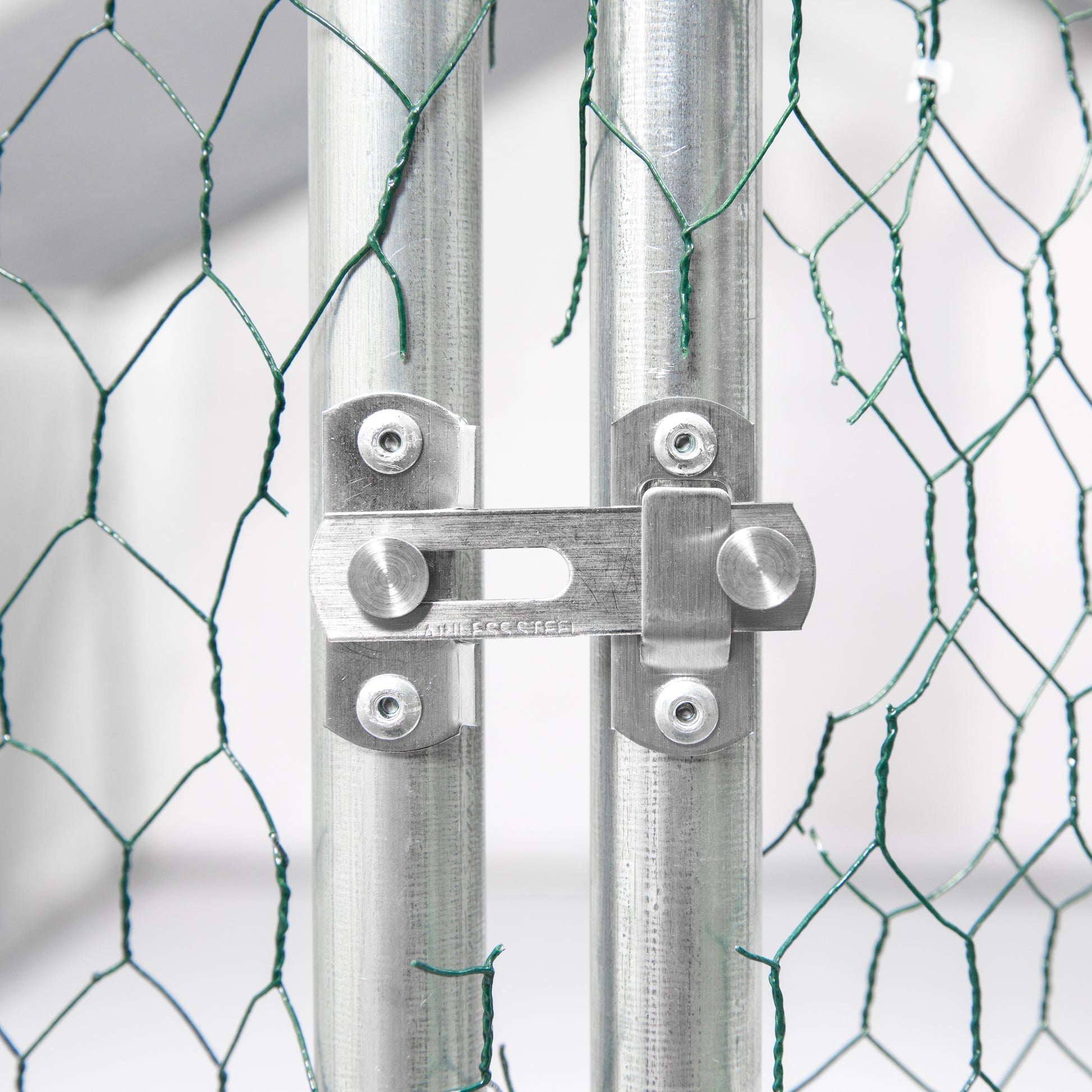 Stainless steel gate latch for secure outdoor enclosure attached to galvanized posts