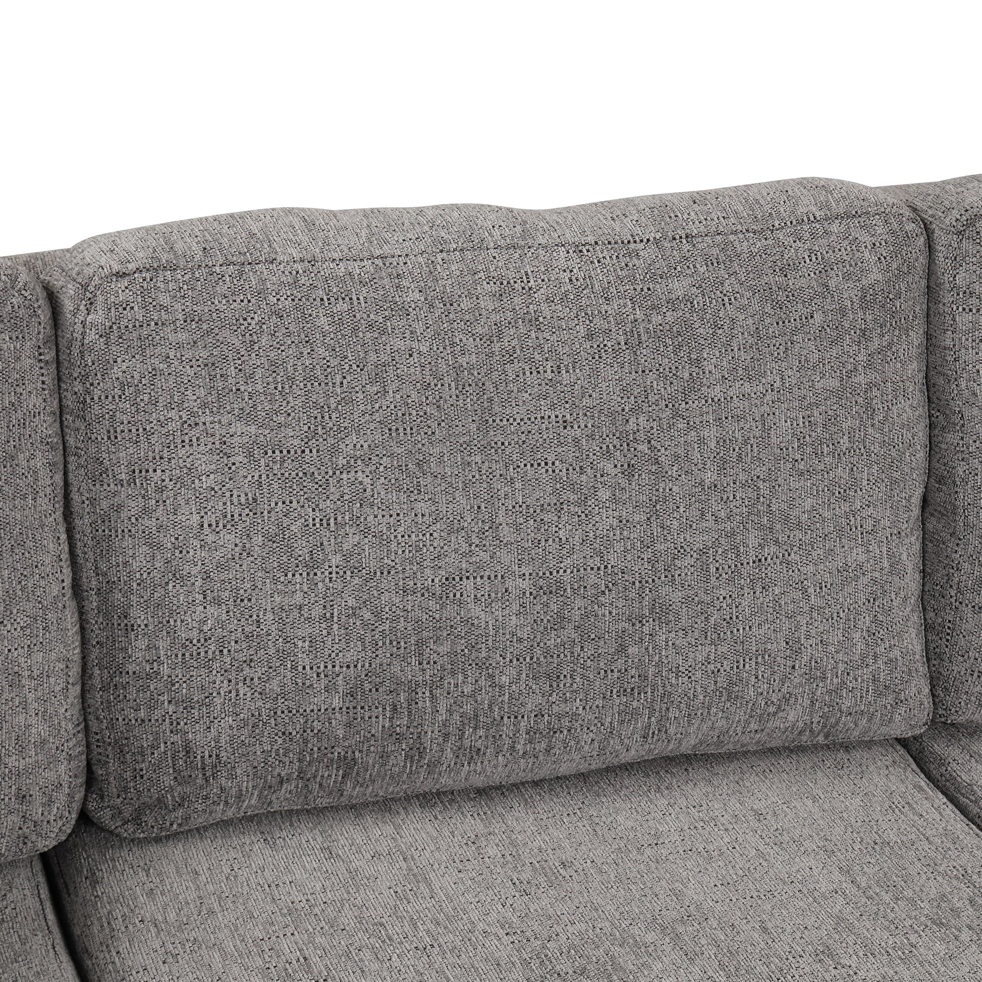 Closeup of a textured grey fabric couch cushion with stitched details