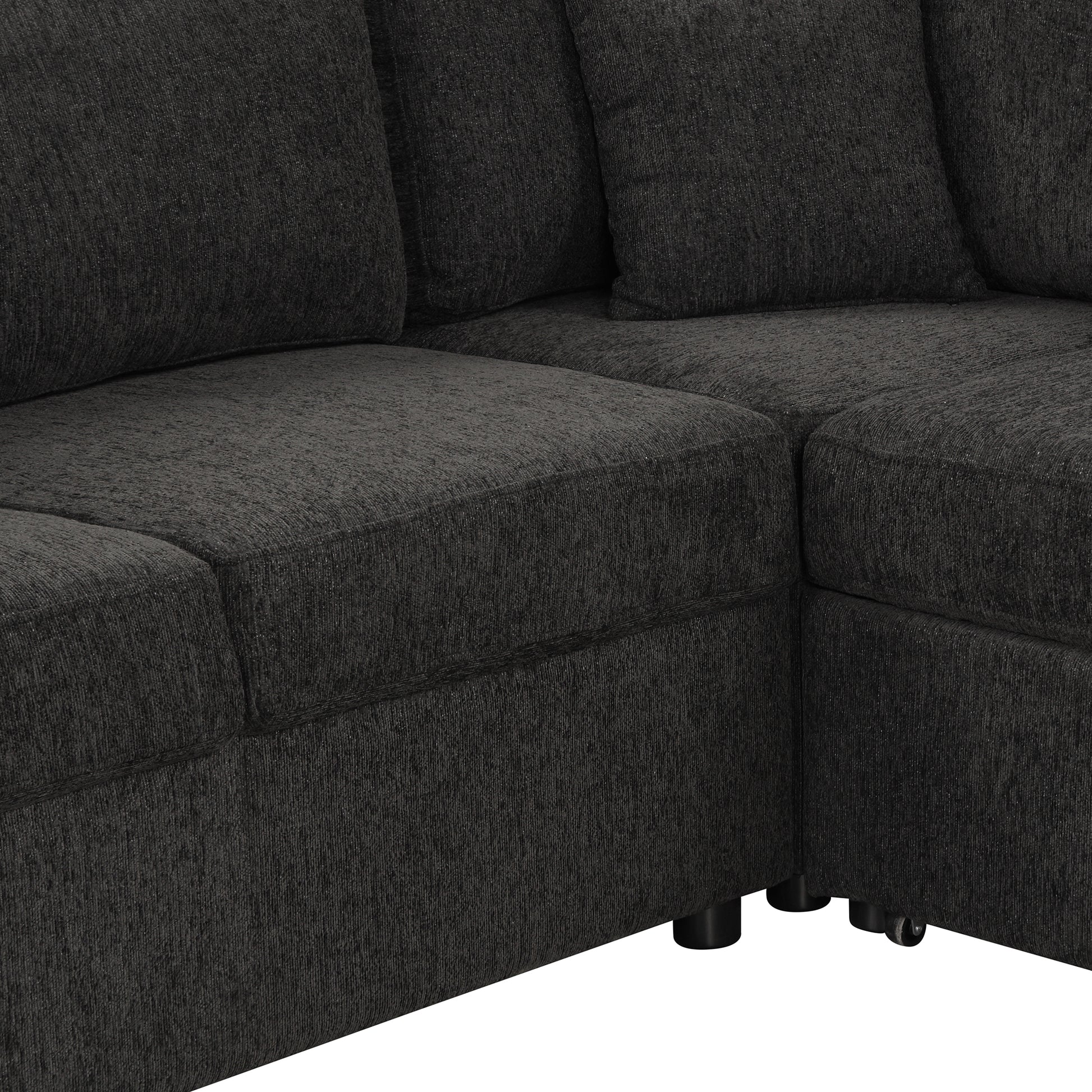 Closeup of plush charcoal grey sectional sofa upholstery with textured fabric detail