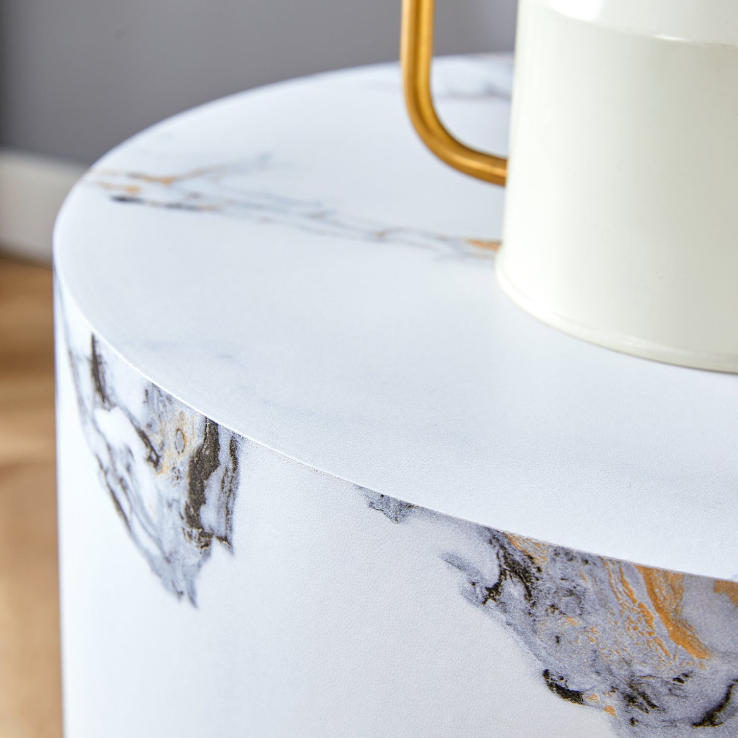 Round side table with white marblelook top and gold accents modern style