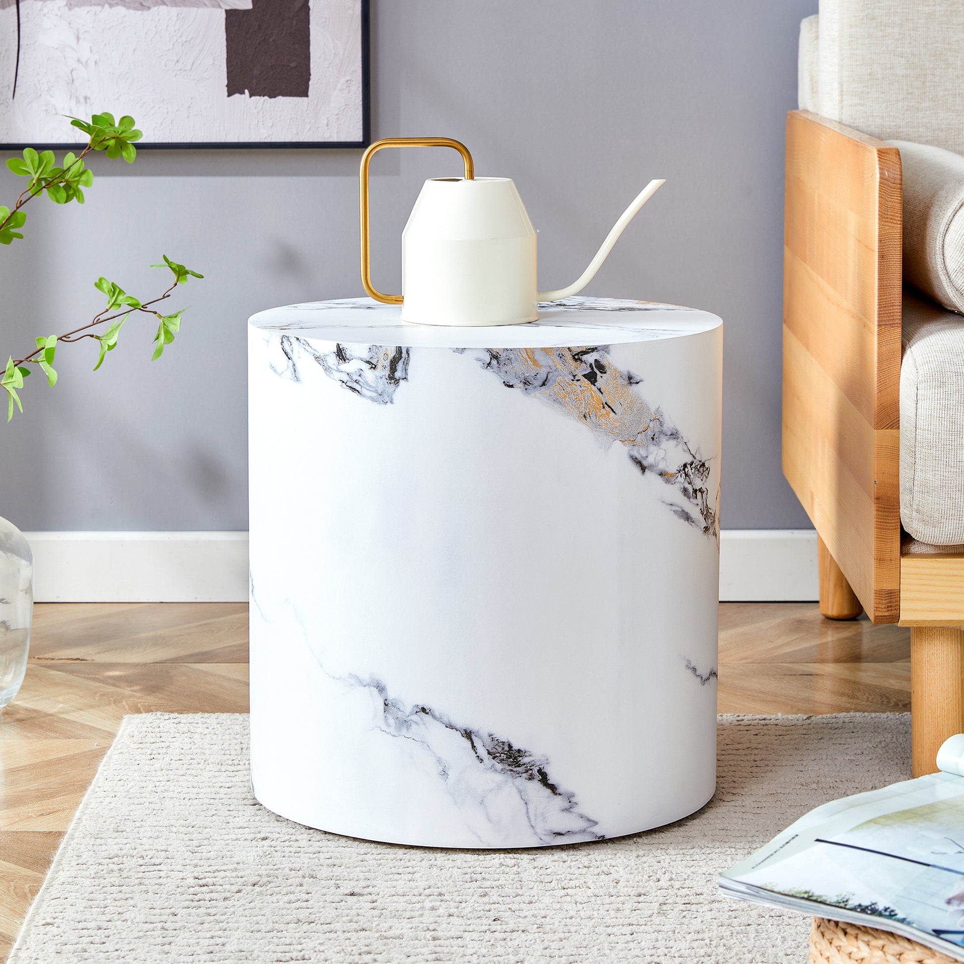 Modern white cylinder side table with marbleinspired black and gold veining