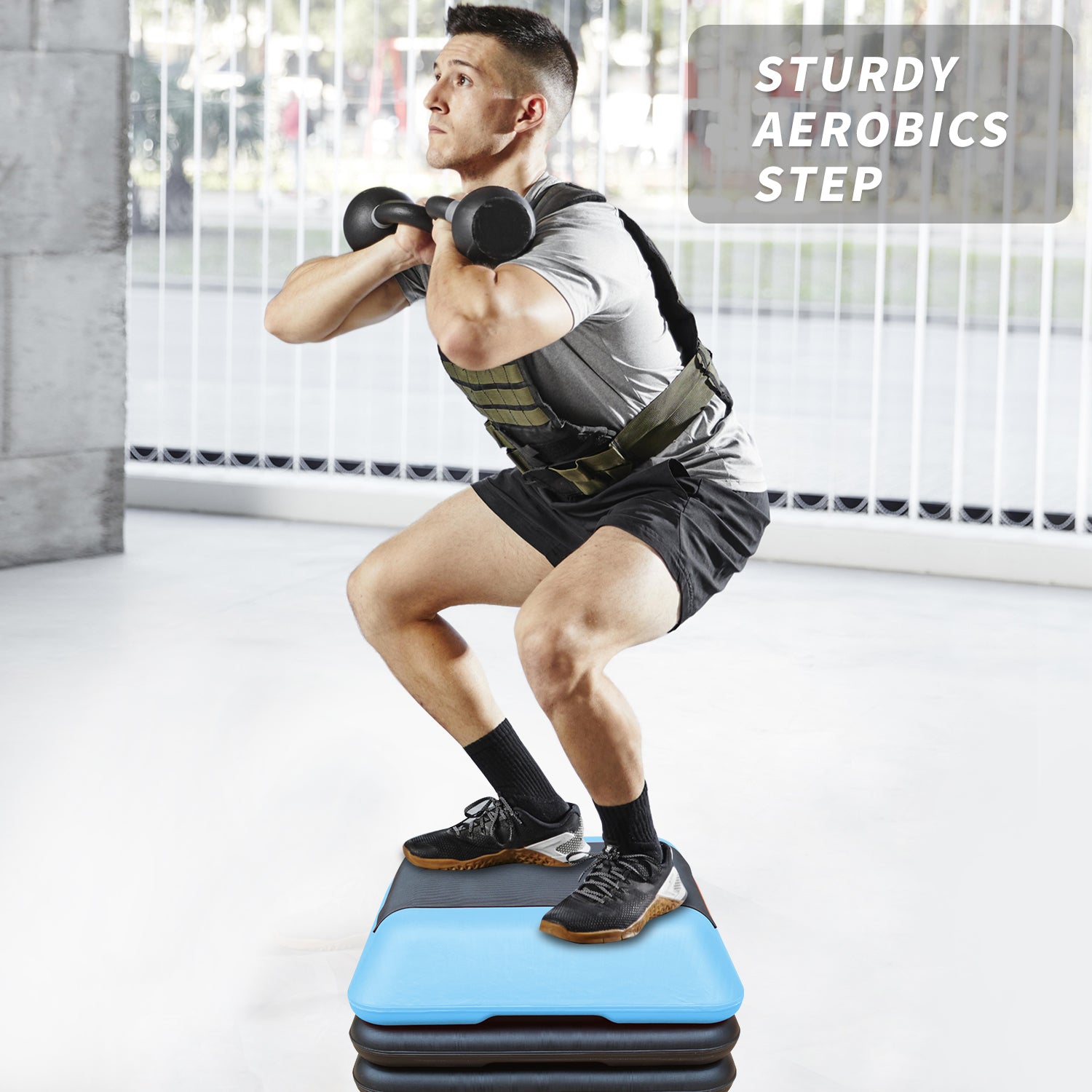 Man performing a squat on a sturdy aerobics step holding a dumbbell for weight training