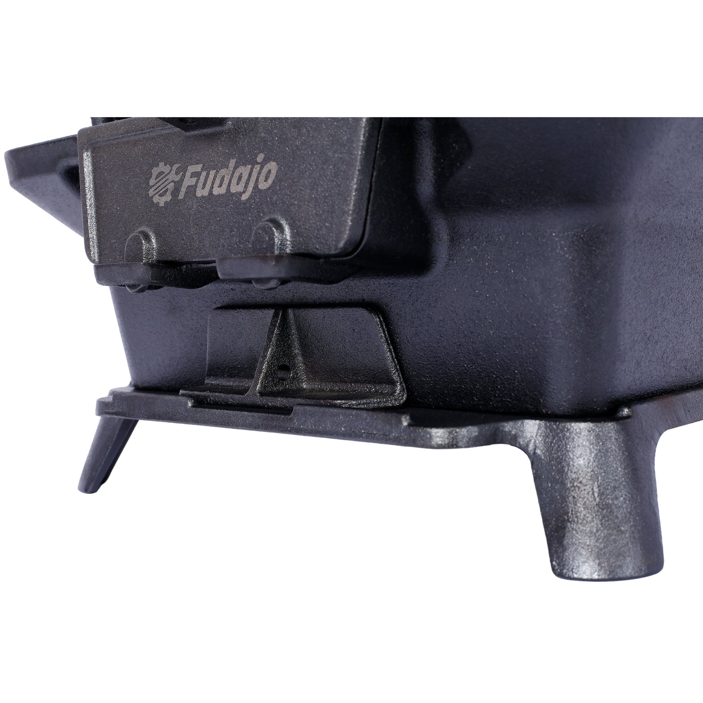 Closeup of a black cast iron camping stove with the Fudajo logo embossed