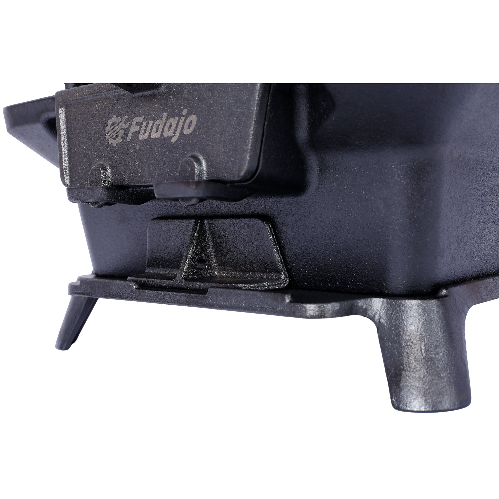 Closeup of a black cast iron camping stove with the Fudajo logo embossed