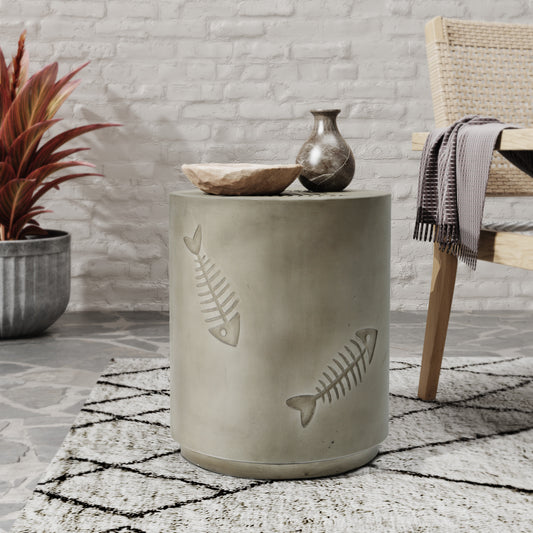 Gray concrete drum side table with embossed fish skeleton design perfect for modern patios