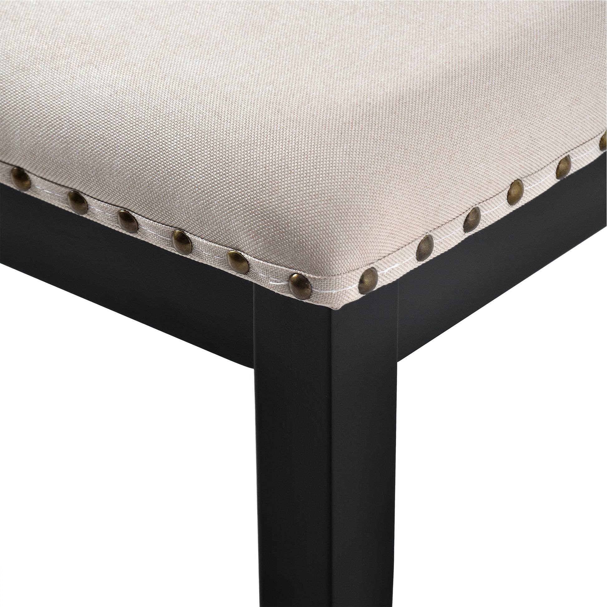 Beige linen upholstered bench with antique brass nailhead trim and black legs