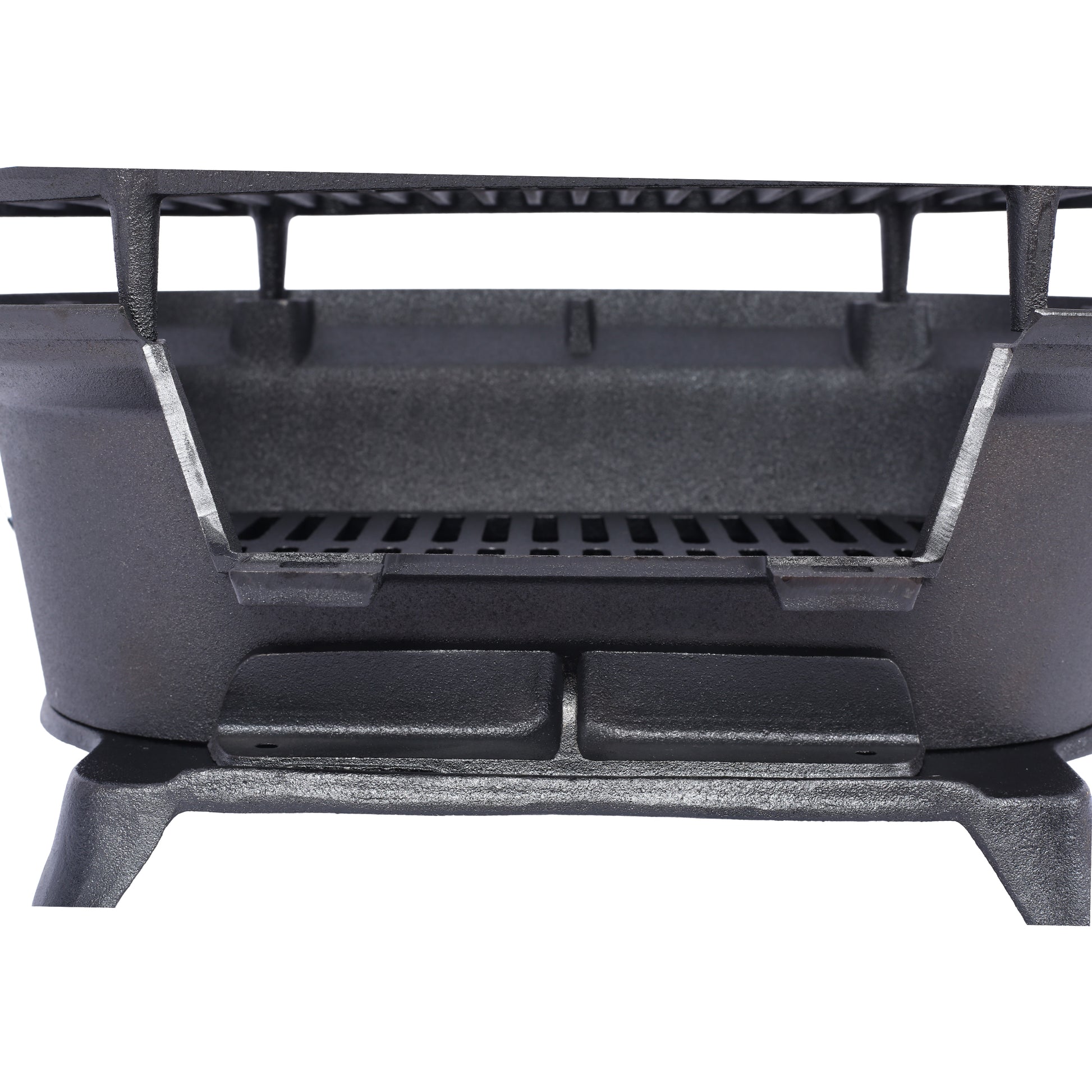 Closeup of a black cast iron charcoal grill grate with sturdy legs and a textured finish