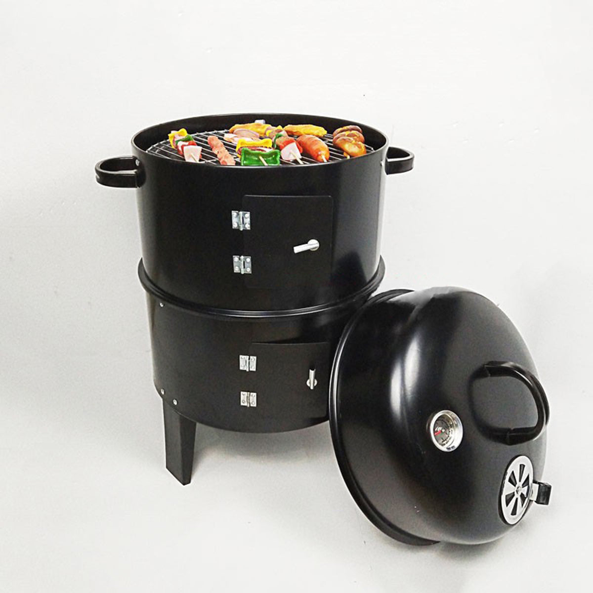 Black charcoal smoker grill with food ready for cooking
