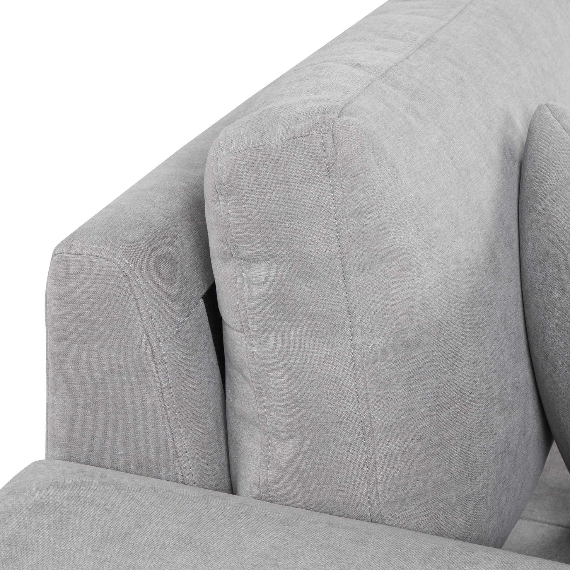 Closeup of textured grey fabric sofa armrest with stitched detailing