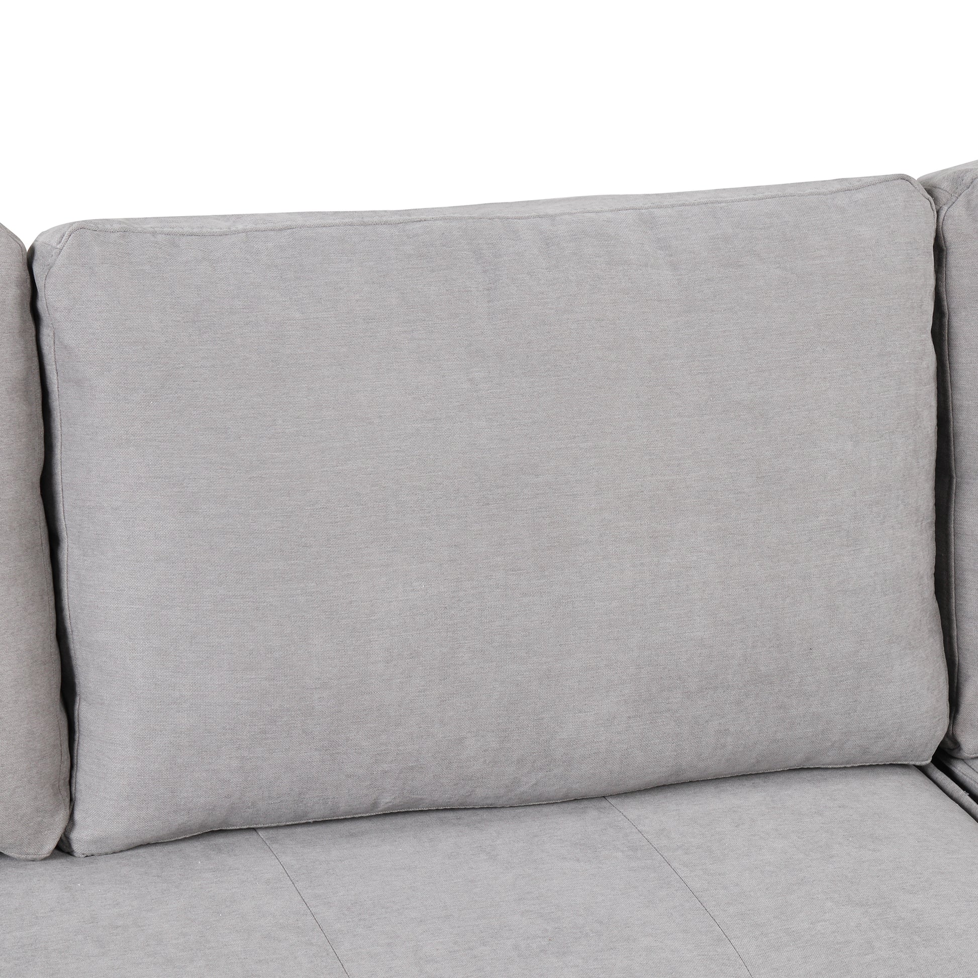 Closeup of a plush light gray fabric couch cushion showcasing its textured weave