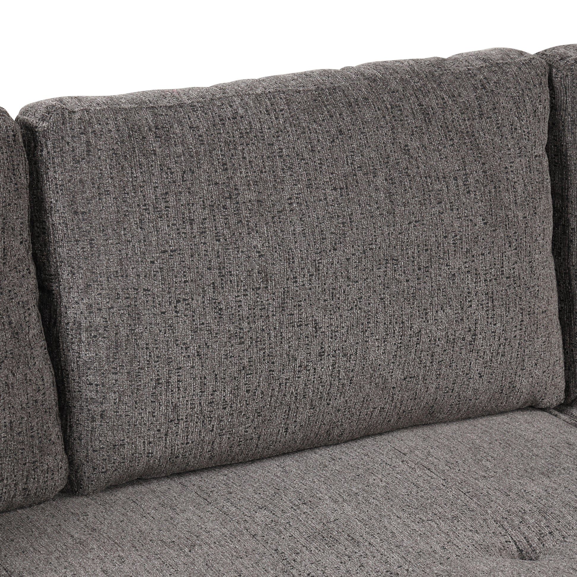 Closeup of a plush dark grey textured fabric sofa cushion