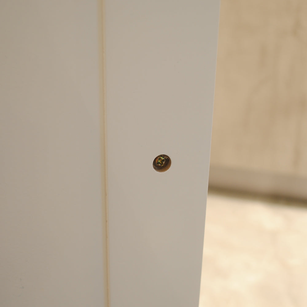 Flat head screw on white panel