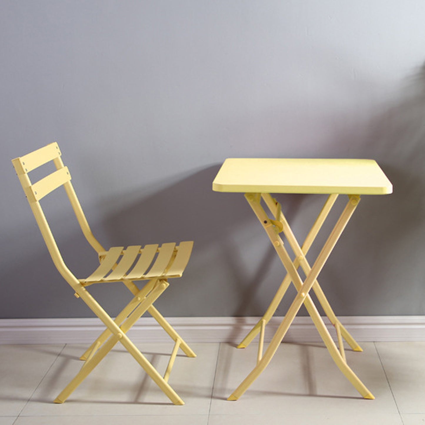 Yellow metal folding bistro chair with slatted seat and back
