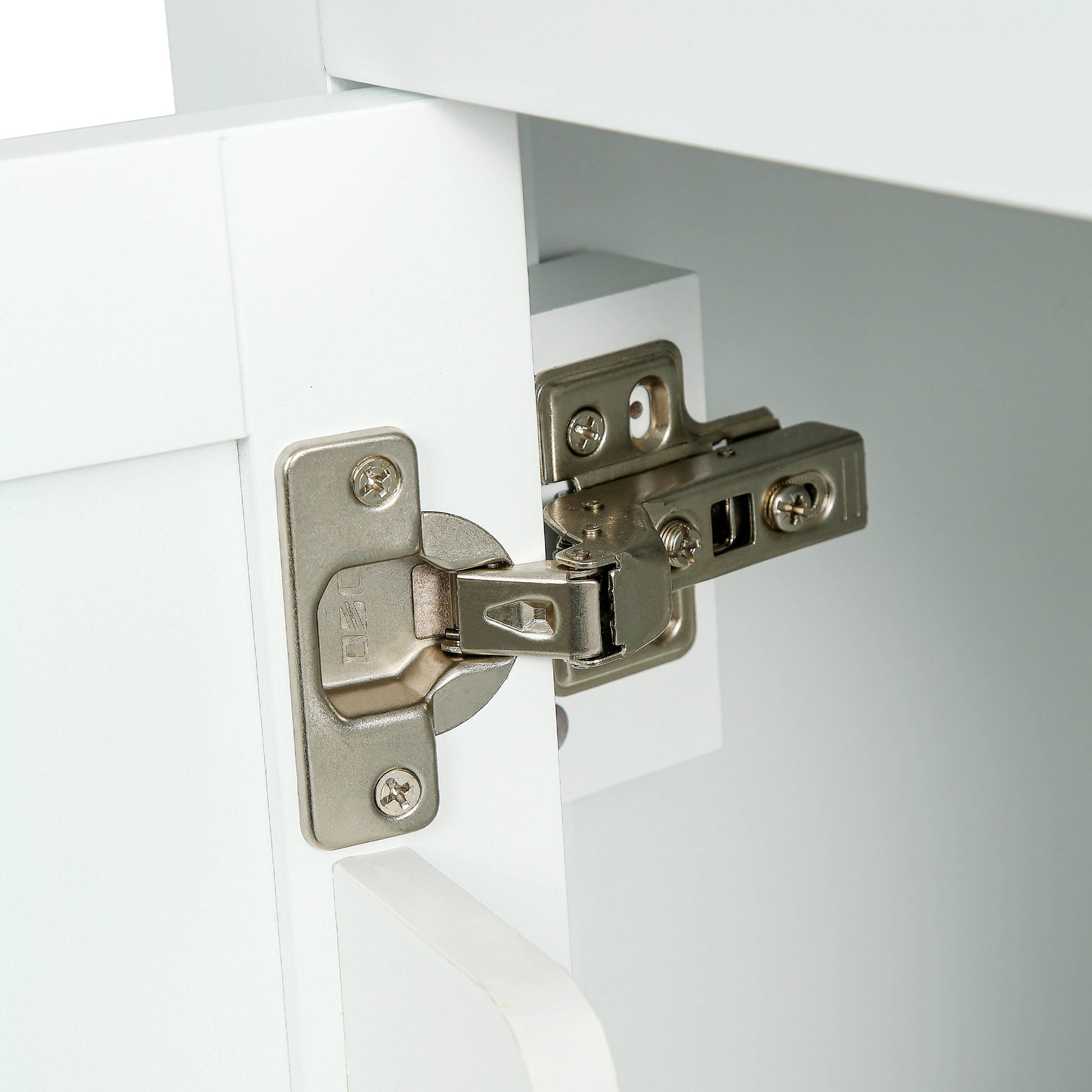 Closeup of a brushed nickel cabinet hinge for kitchen cabinet doors