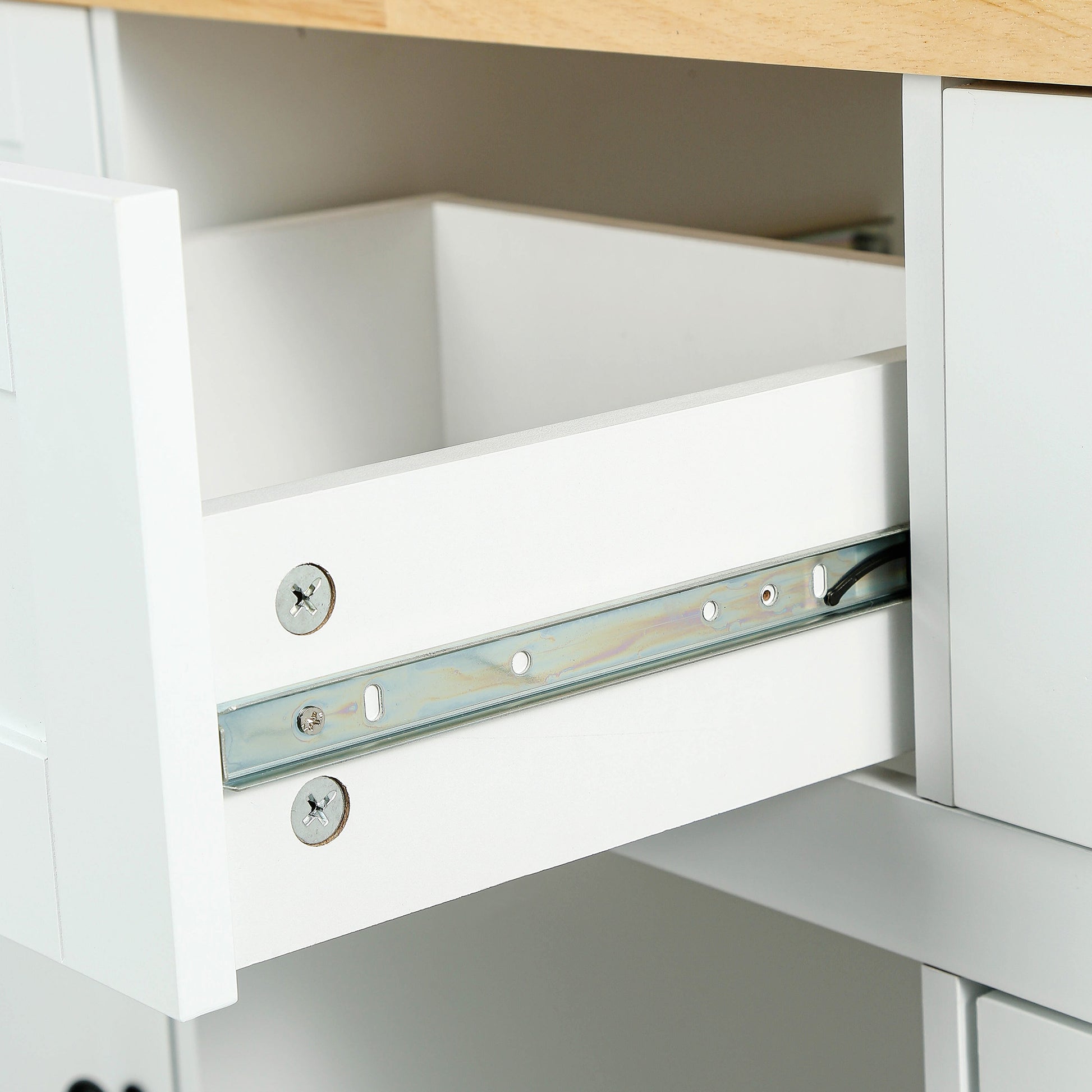 White kitchen cabinet drawer interior with metal slide hardware