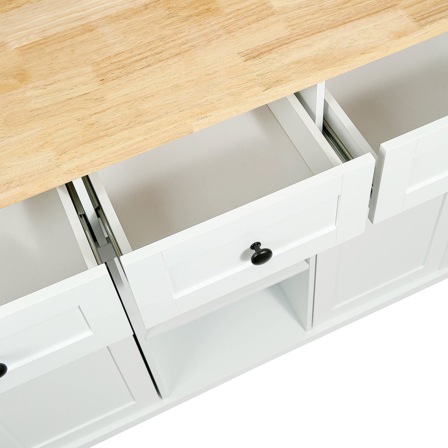 White kitchen island with butcher block top and open drawers