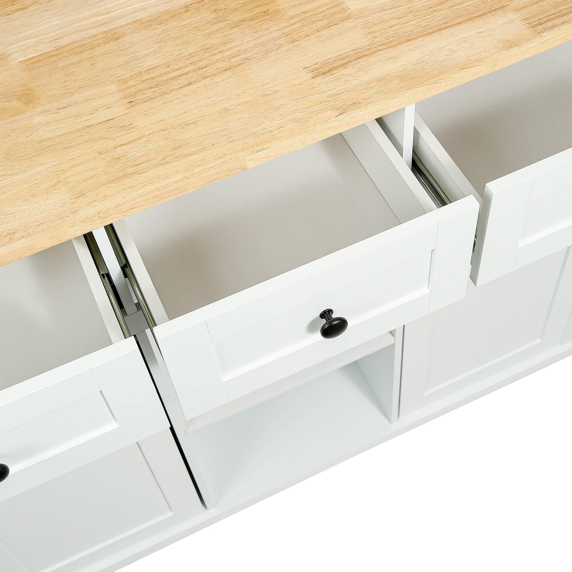 White kitchen island with butcher block top and open drawers