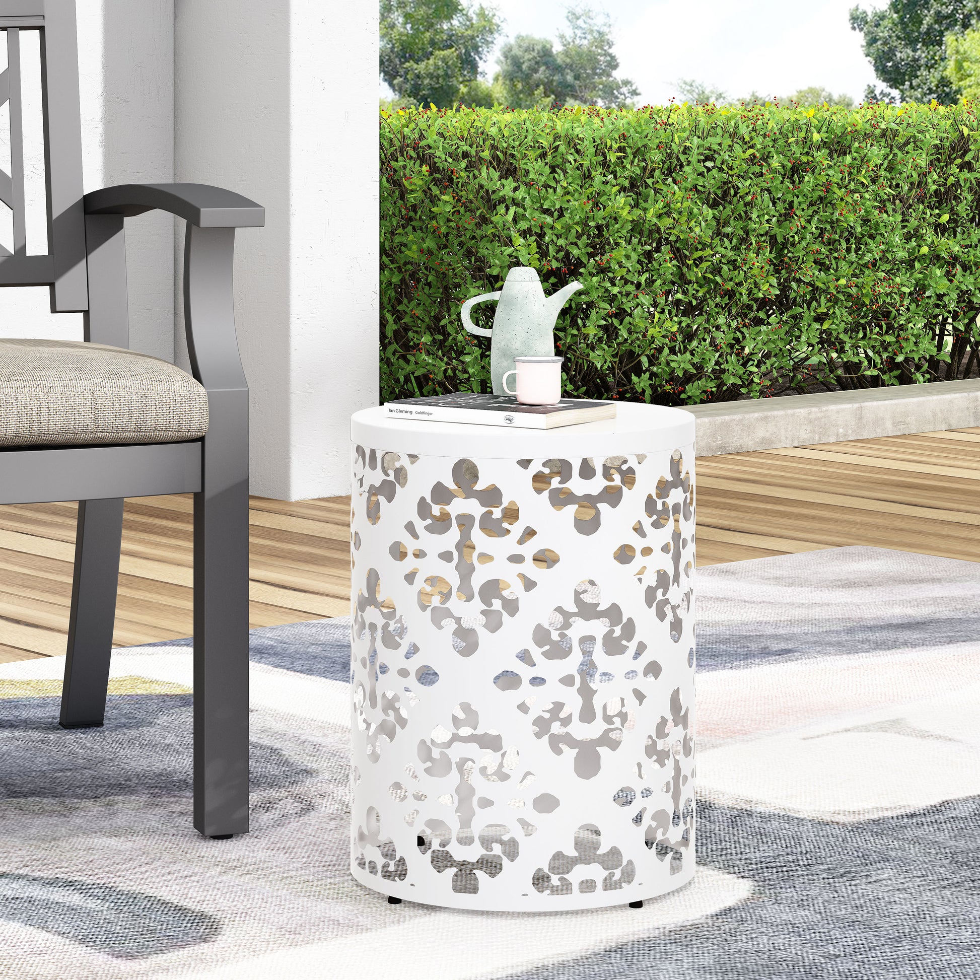 White lasercut metal outdoor accent table with geometric pattern ideal for patio seating