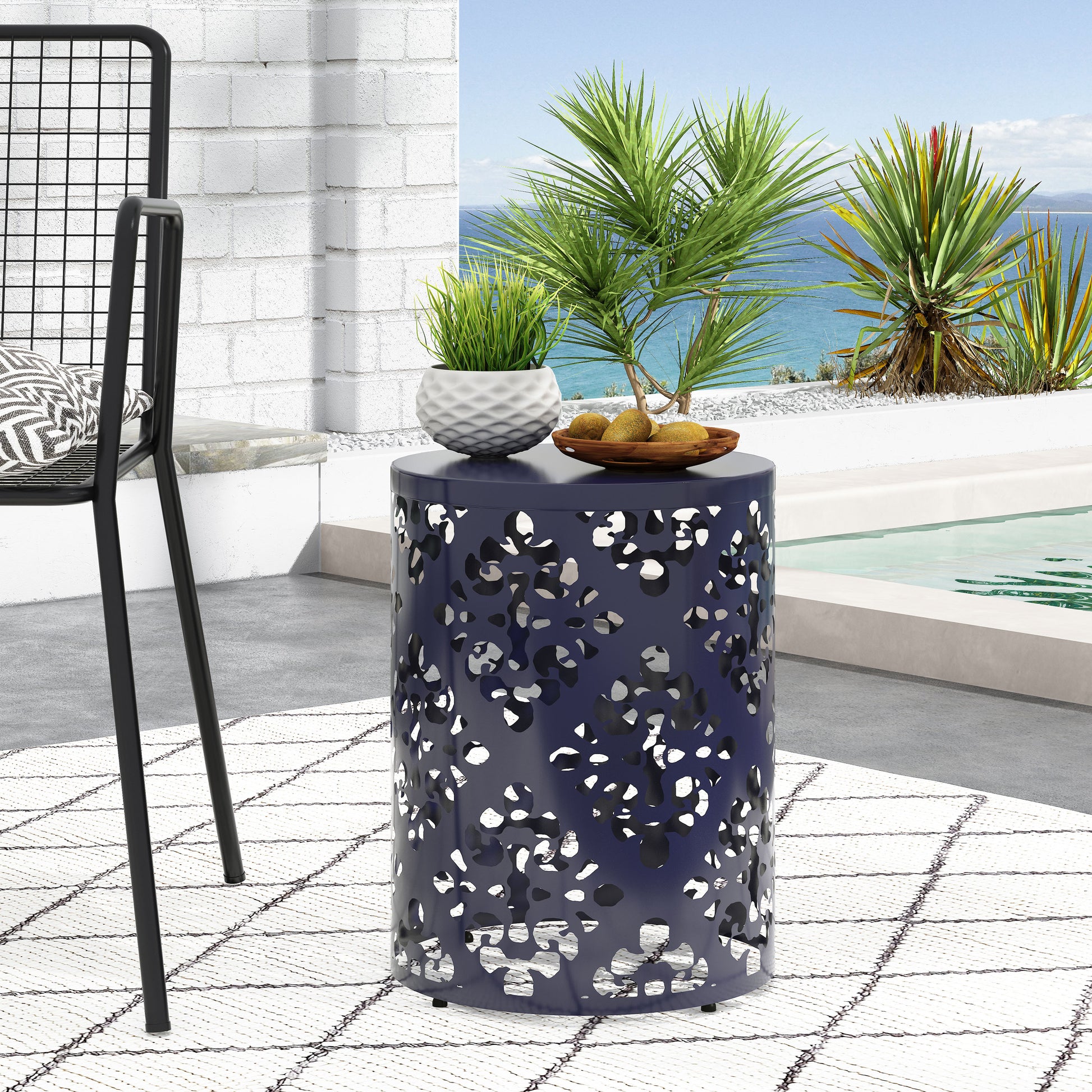 Navy blue metal outdoor side table with lasercut floral pattern perfect for patio decor