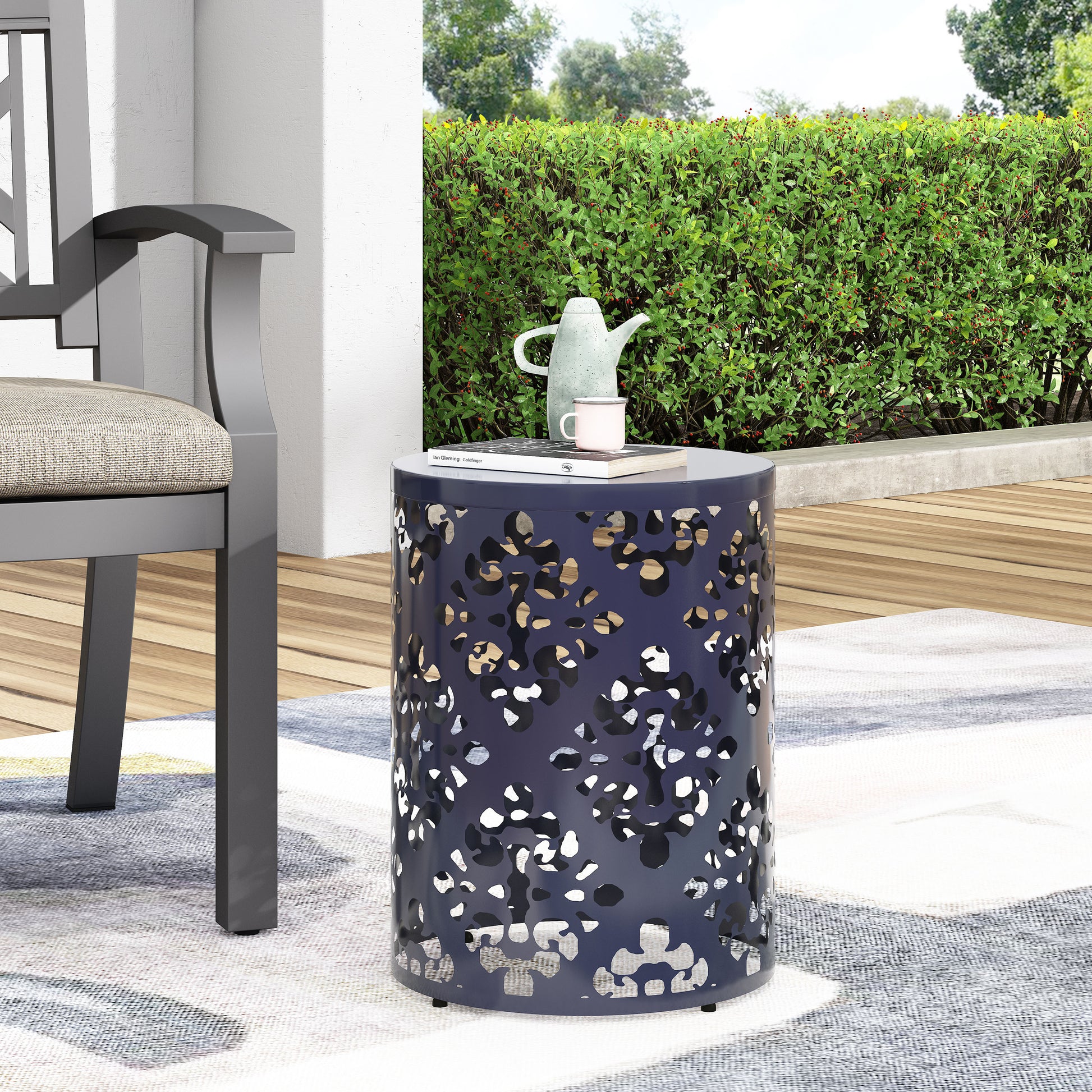 Dark blue metal garden side table with a lasercut abstract pattern