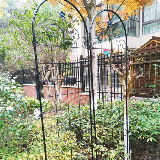 Black wrought iron garden trellis with rose accents for climbing plants