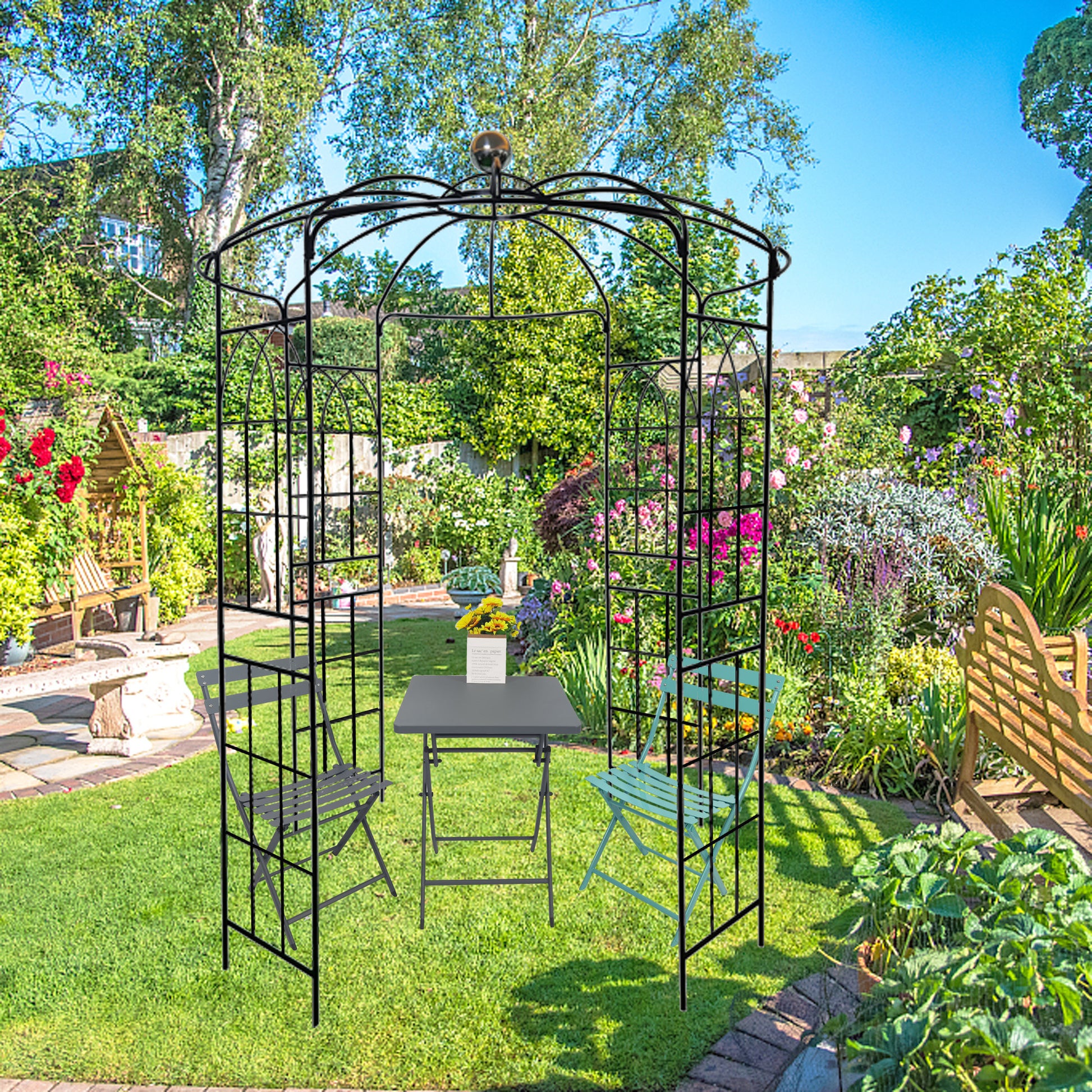 Black metal garden archway with ornate scrolling and a central finial