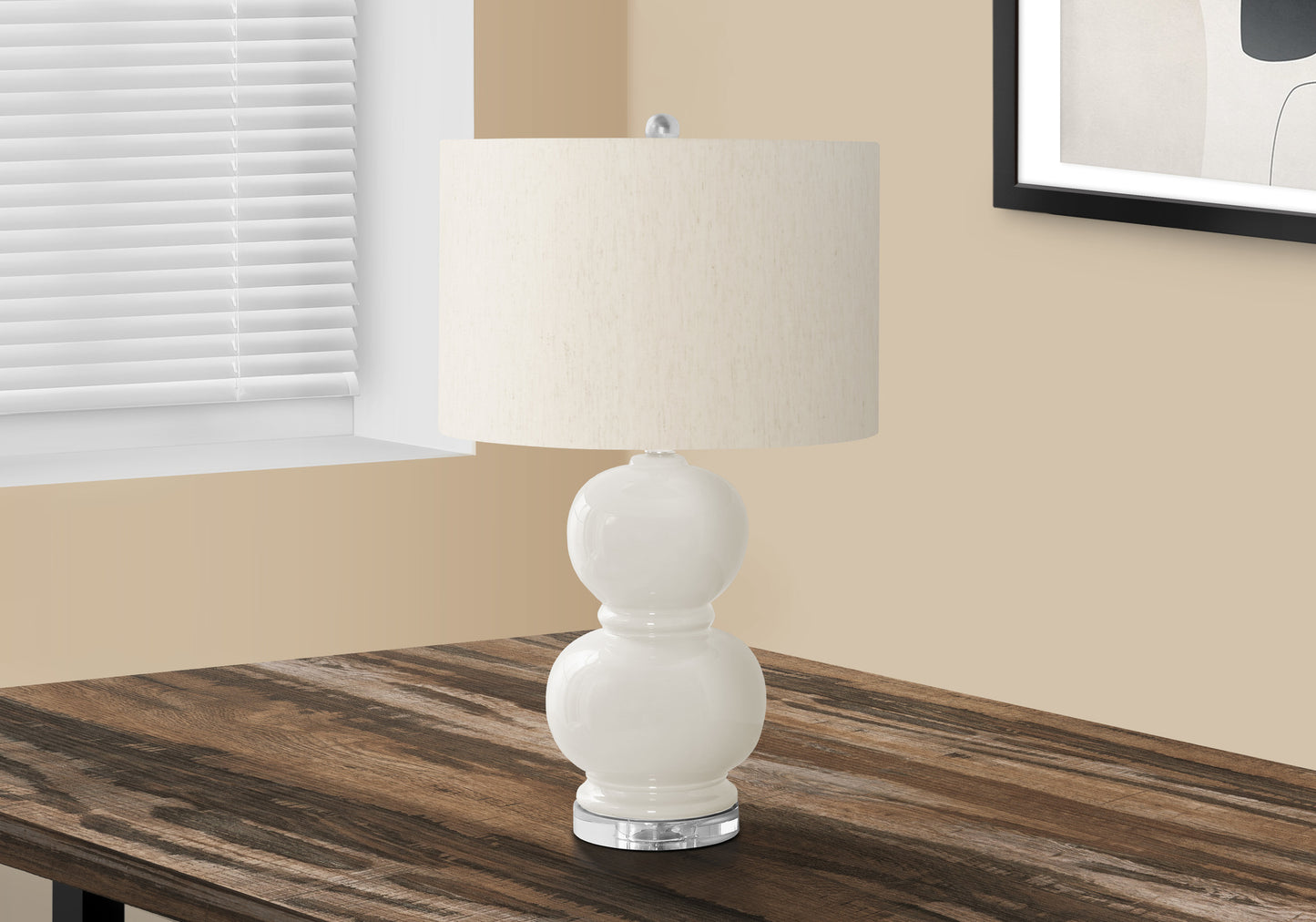 White ceramic table lamp with rounded base and cream fabric shade
