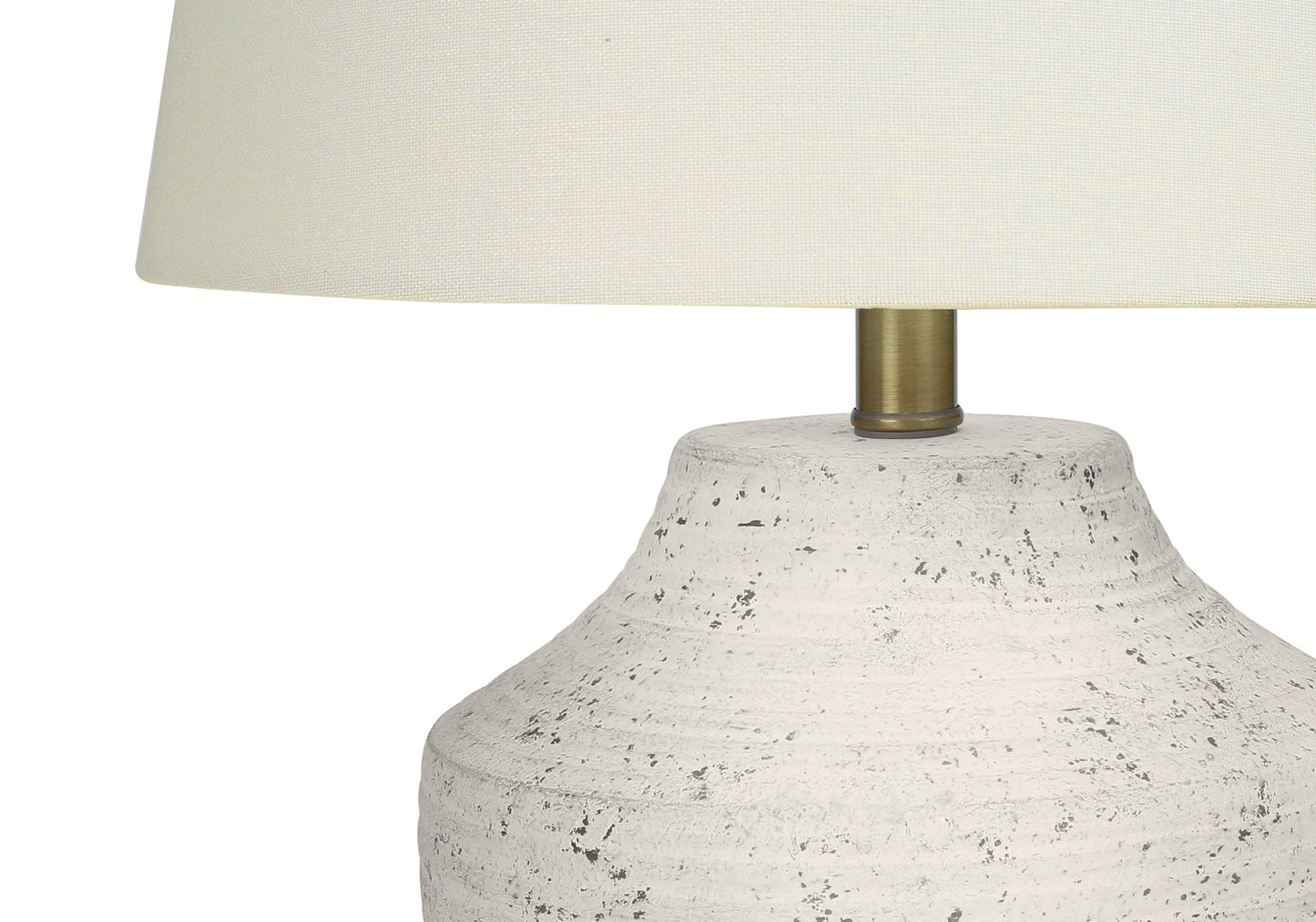 Cream textured ceramic table lamp with a natural linen shade and brass hardware