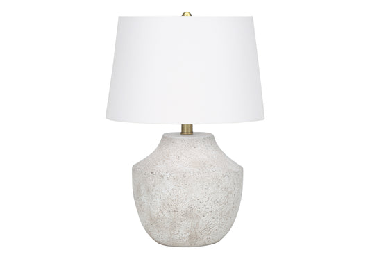 Textured ceramic table lamp with white linen shade and brass accents