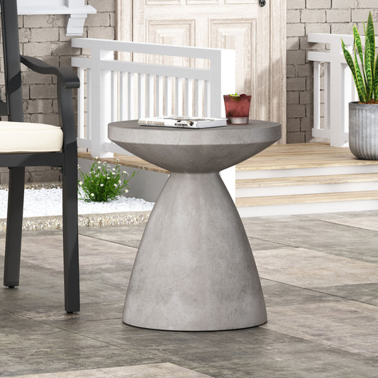 Round grey concrete outdoor side table with modern pedestal base