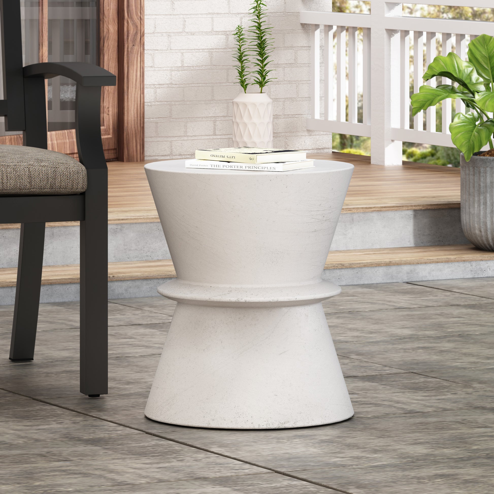 Concrete hourglass end table with textured surface perfect for patio decor