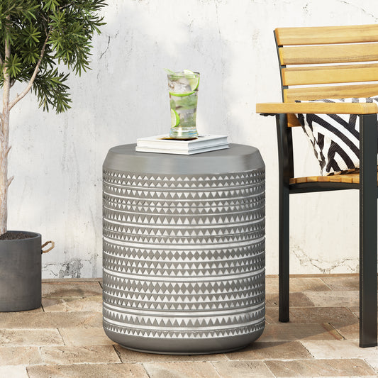 Round grey outdoor side table with geometric pattern and metal legs