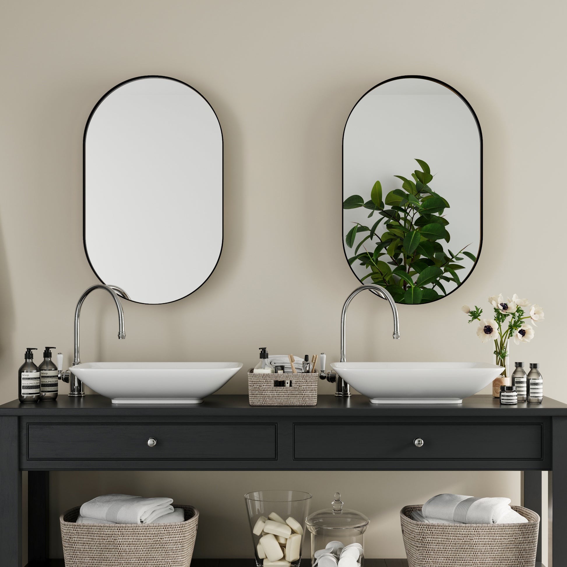 Modern bathroom vanity with double vessel sinks and oval mirrors featuring chrome faucets and dark wood base